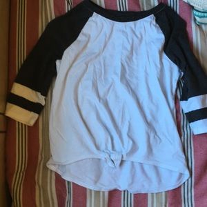 A t shirt that is white and has black sleeves